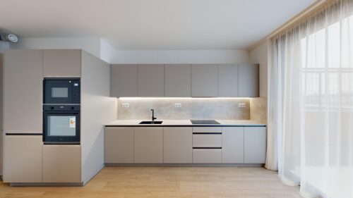 Contemporary kitchen with gray flat-panel cabinets, built-in oven and microwave, and a light marble backsplash under soft lighting.