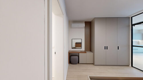 Modern hallway with built-in gray wardrobes, a small wooden desk, a wall mirror, vertical wood slats, and a large glass wall on the right.